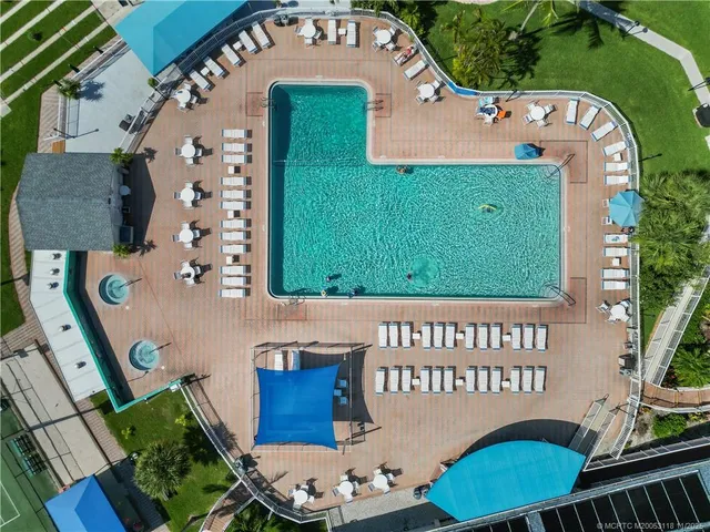 a view of a lake with a table and chairs