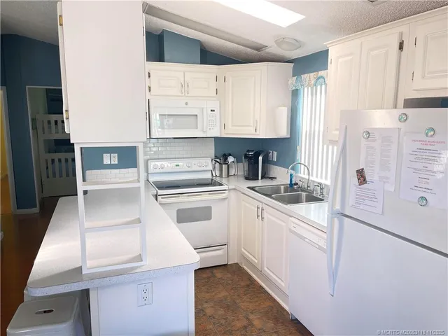 a living room with furniture a flat screen tv and a large window