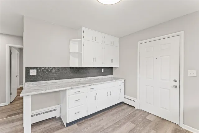 a kitchen with white cabinets