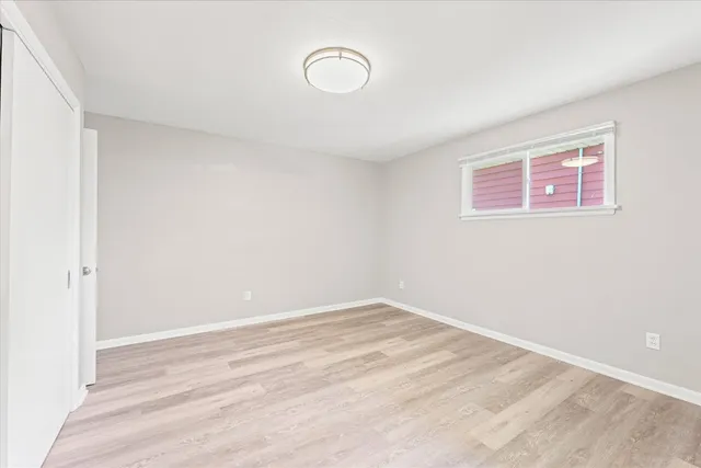 a view of a room with wooden floor and white walls
