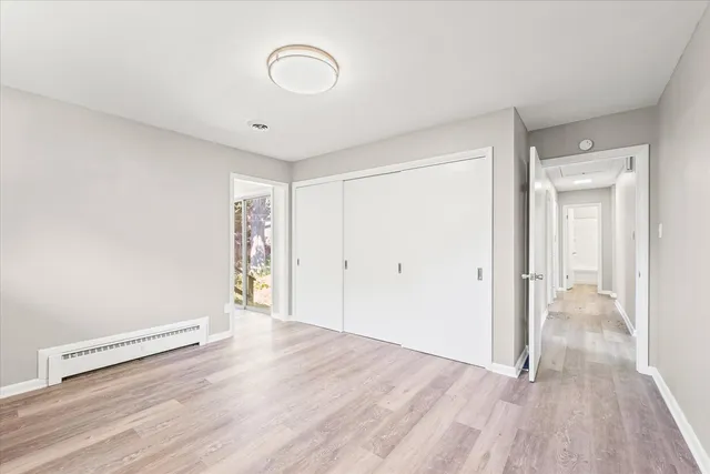 a view of a room with wooden floor and white walls