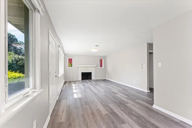a view of a livingroom with wooden floor and window