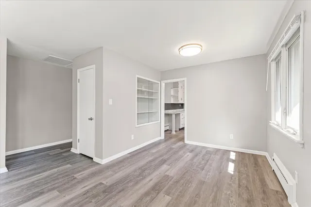 wooden floor in an empty room with a window