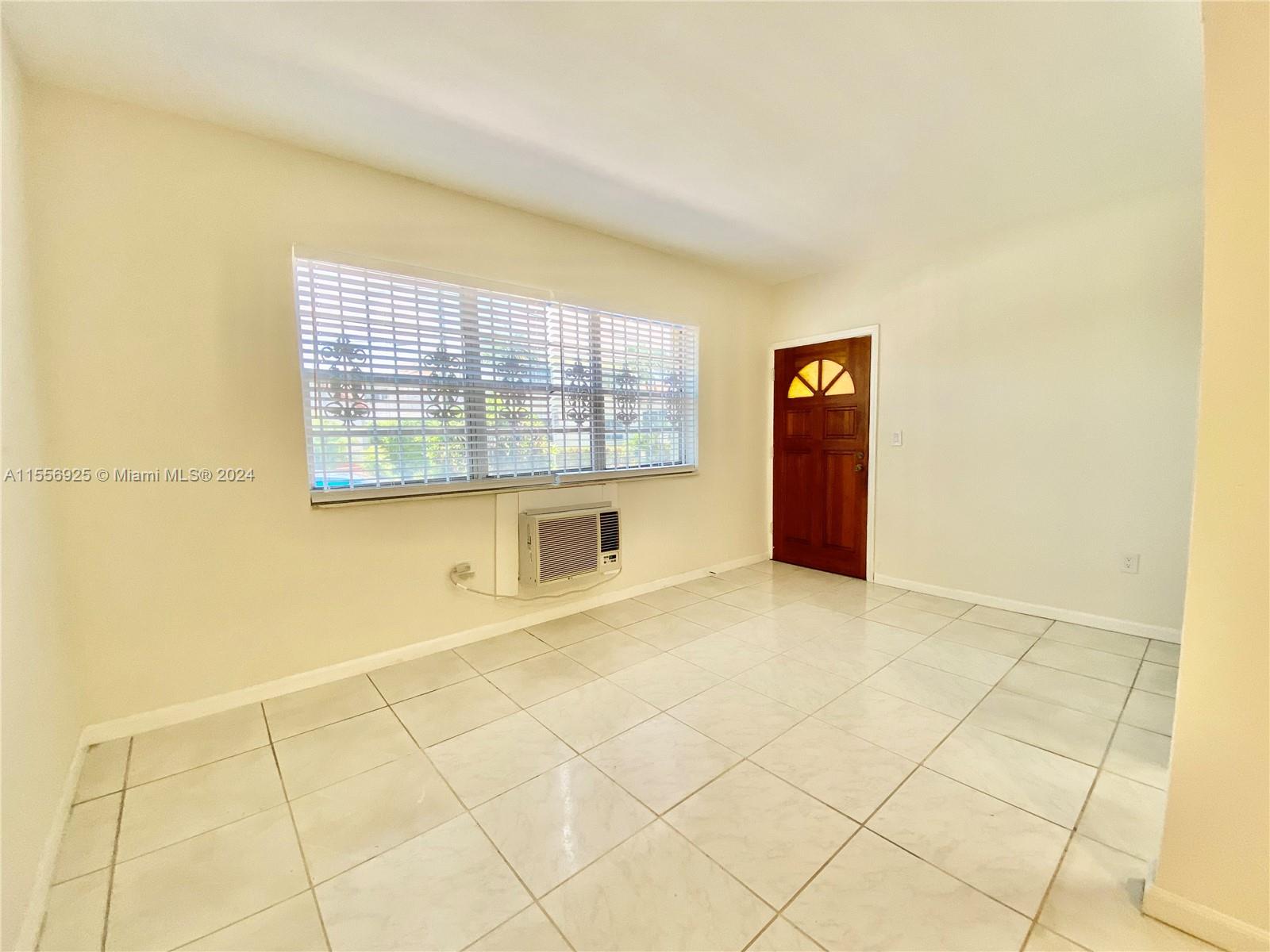 7625 Harding Avenue, Unit 1 Miami Beach, FL 33141 - Photo 4 of 11 a view of an empty room with a window