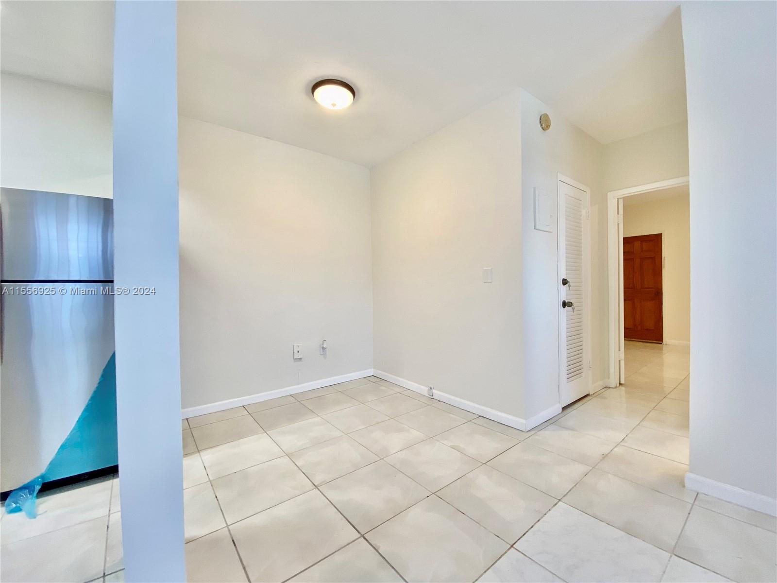 7625 Harding Avenue, Unit 1 Miami Beach, FL 33141 - Photo 5 of 11 a view of an empty room and wooden floor