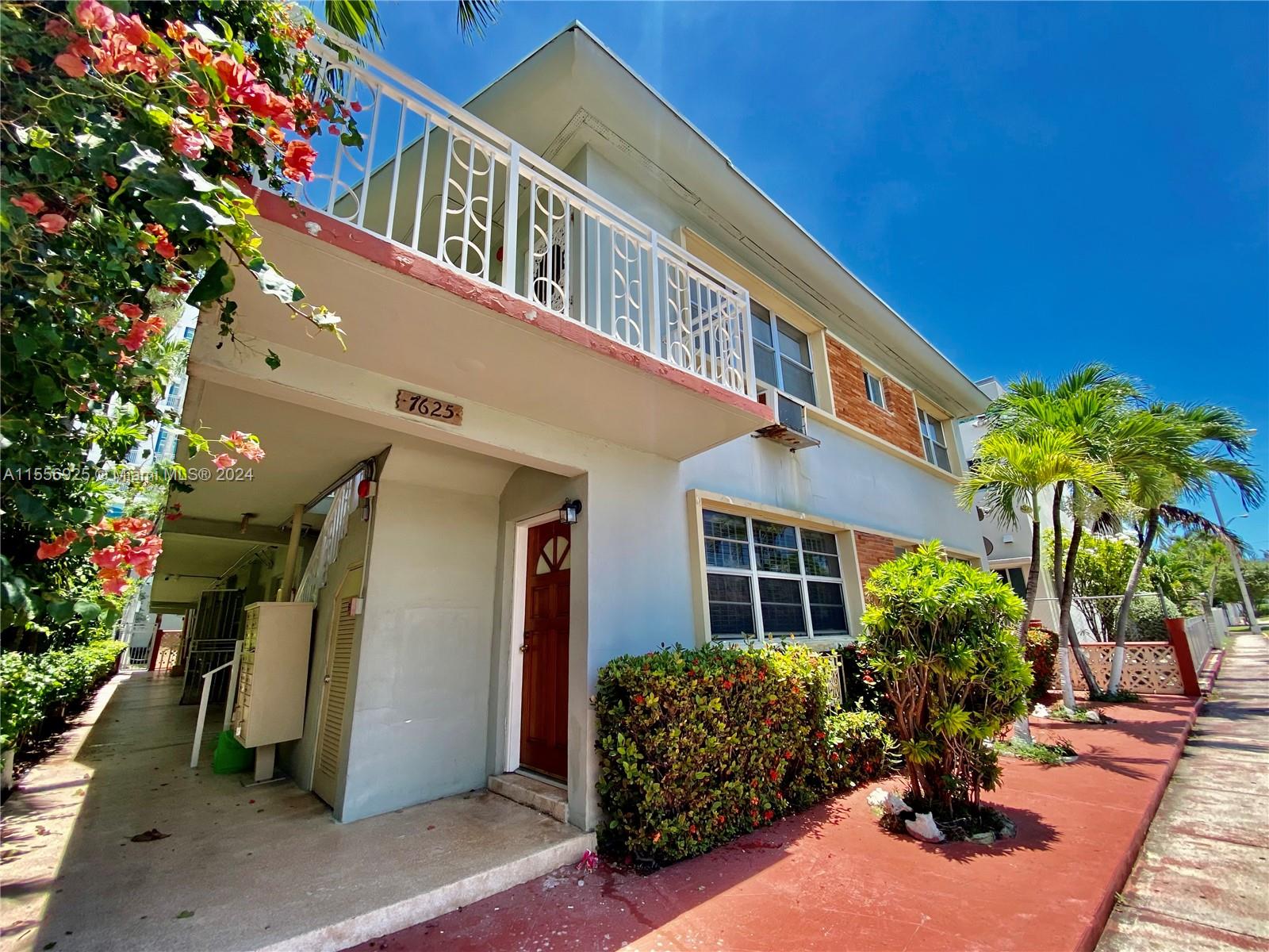 7625 Harding Avenue, Unit 1 Miami Beach, FL 33141 - Photo 10 of 11 a vase of flowers sitting on a floor in front of a house