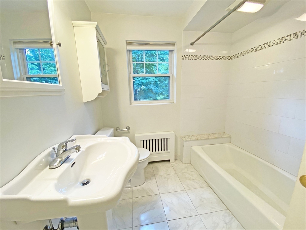 99 Withington Road Newton, MA 02460 - Photo 11 of 33 a bathroom with a sink and a bathtub