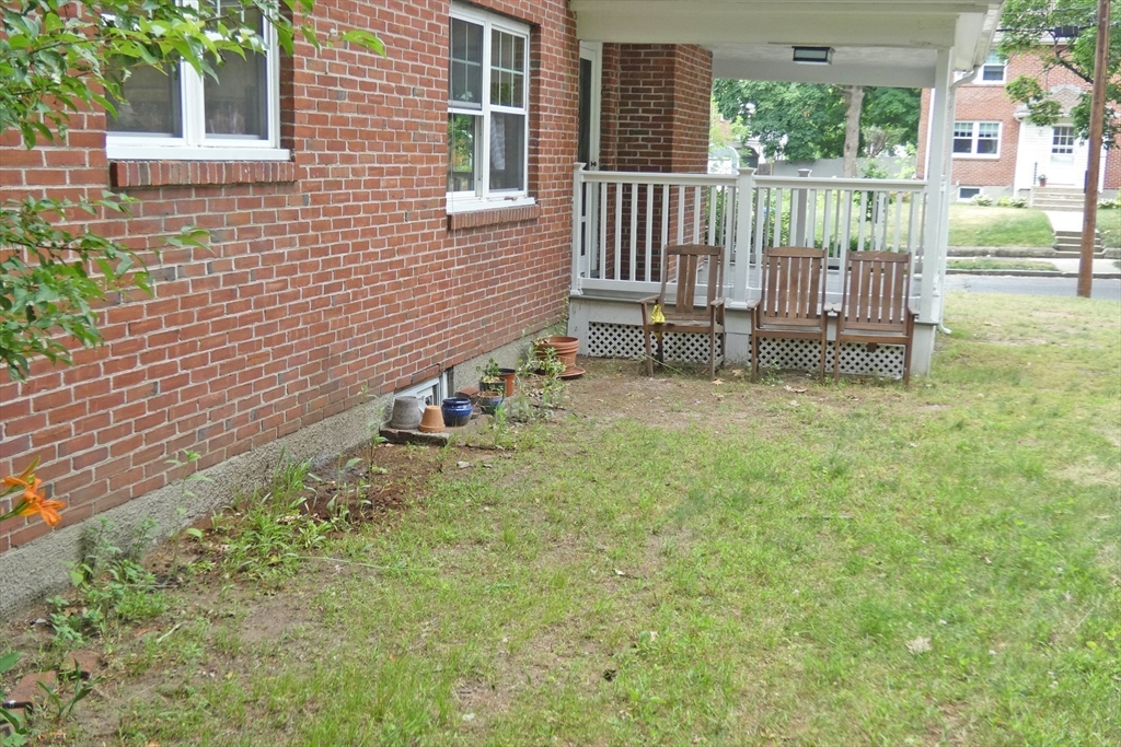 99 Withington Road Newton, MA 02460 - Photo 30 of 33 a backyard of a house with table and chairs