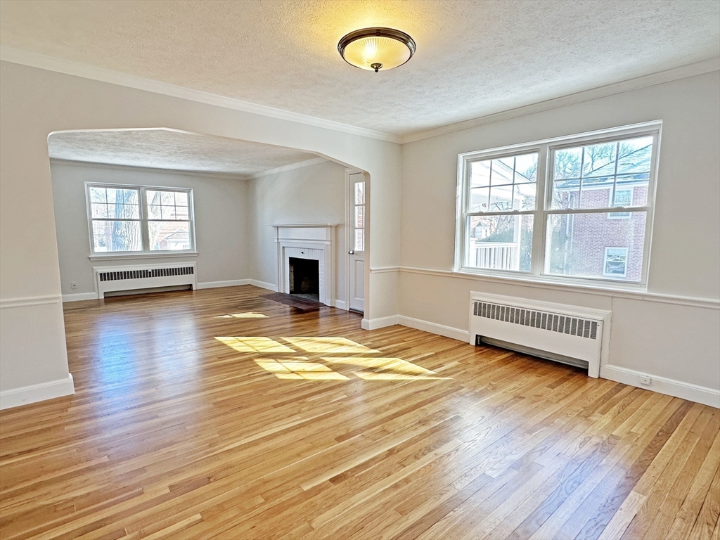 99 Withington Road Newton, MA 02460 - Photo 6 of 33 a view of empty room with wooden floor and fan