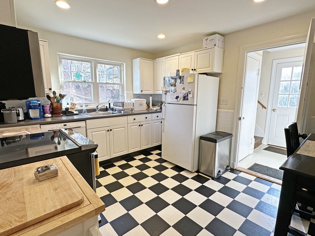 99 Withington Road Newton, MA 02460 - Photo 8 of 33 a kitchen with a sink a stove a refrigerator and cabinets