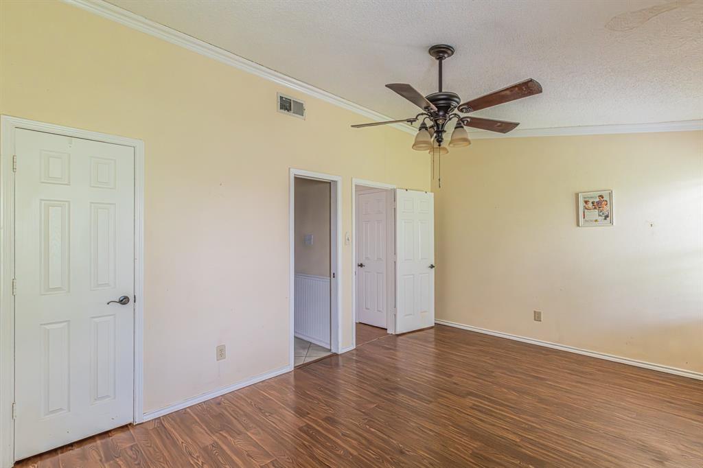 6504 Johnnie Street Watauga, TX 76148 - Photo 19 of 23 Spacious room featuring wood-finish flooring, light-toned walls, and white trim