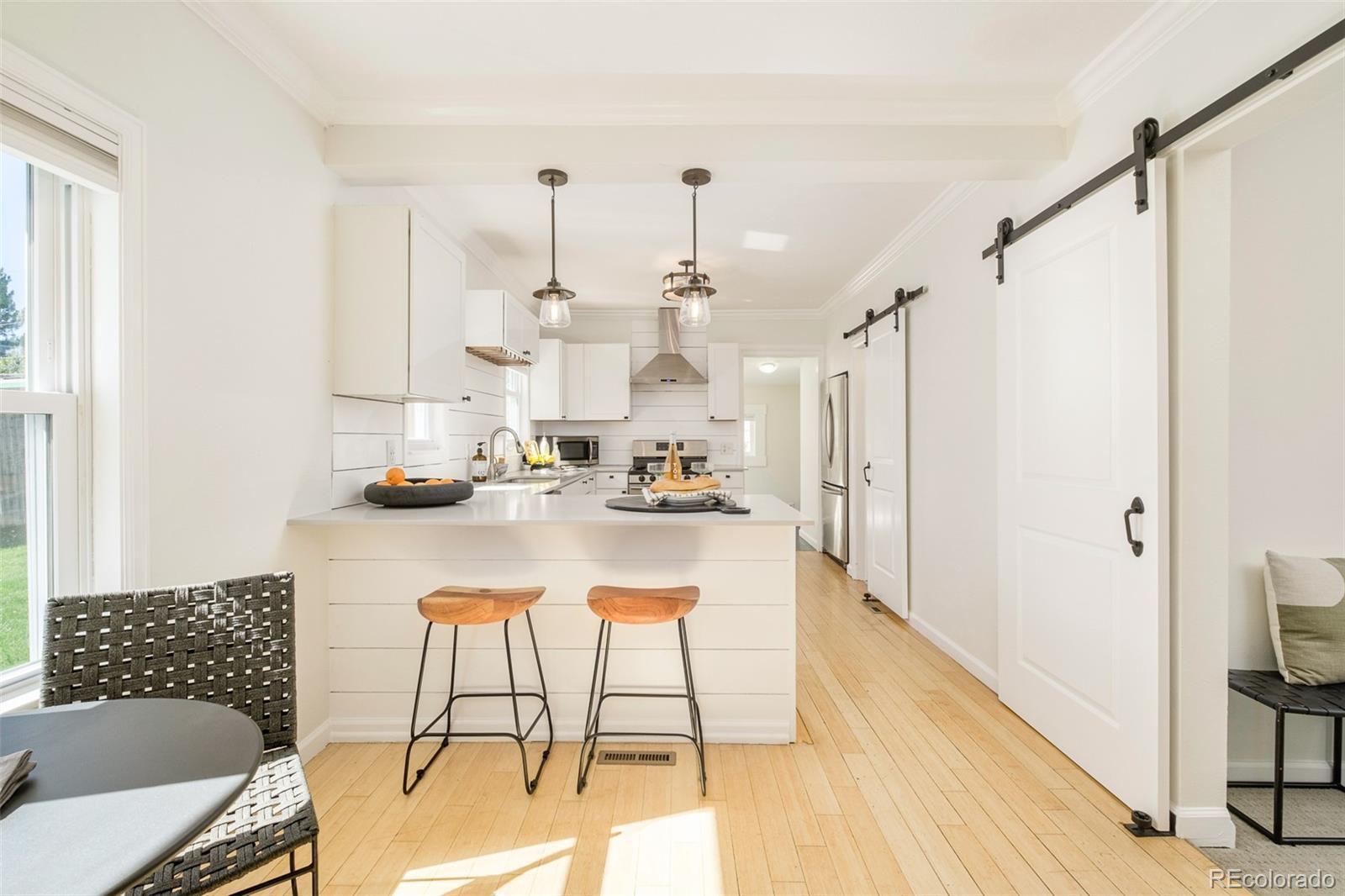 a view of kitchen with furniture and wooden floor