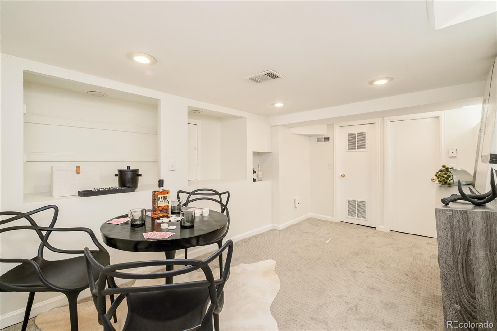 4635 Elm Court Denver, CO 80211 - Photo 19 of 28 a view of a dining room with furniture and a potted plant