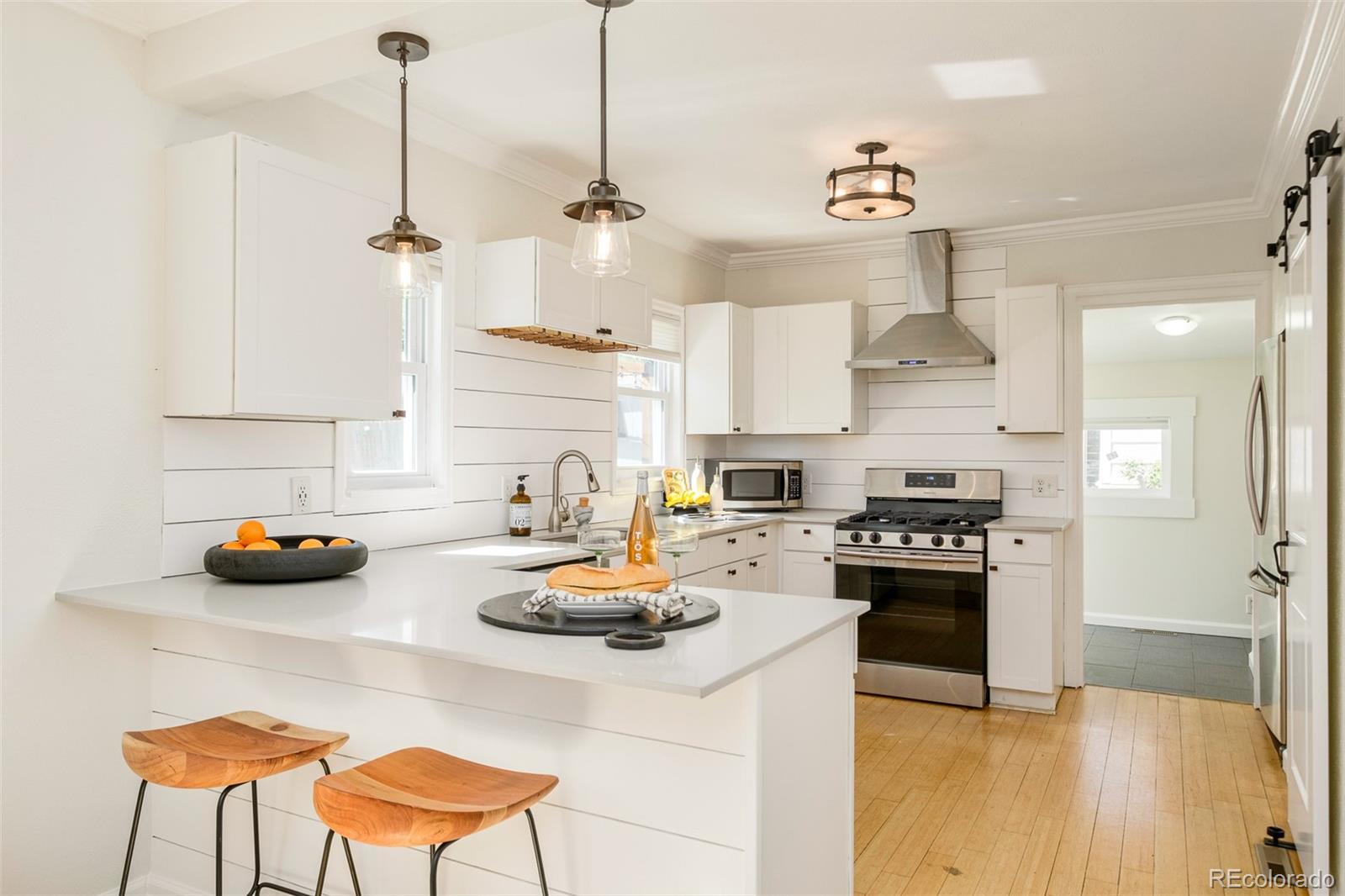 4635 Elm Court Denver, CO 80211 - Photo 2 of 28 a kitchen with sink a stove and chairs