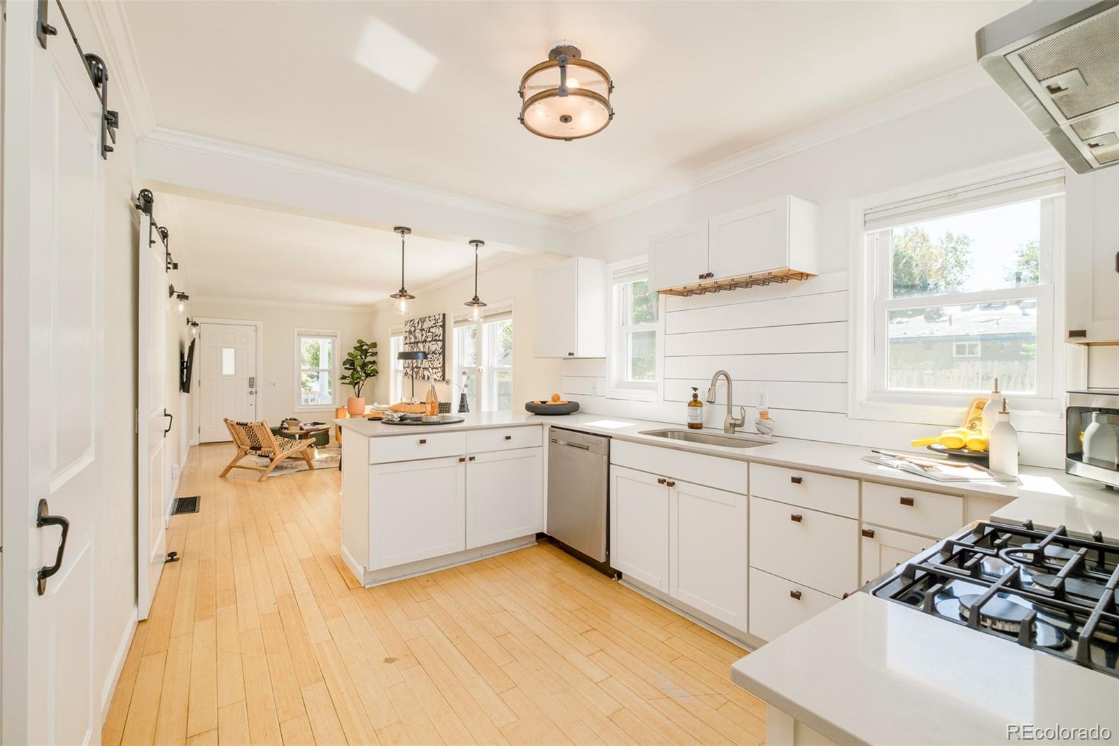 4635 Elm Court Denver, CO 80211 - Photo 4 of 28 a kitchen with a sink a stove and cabinets