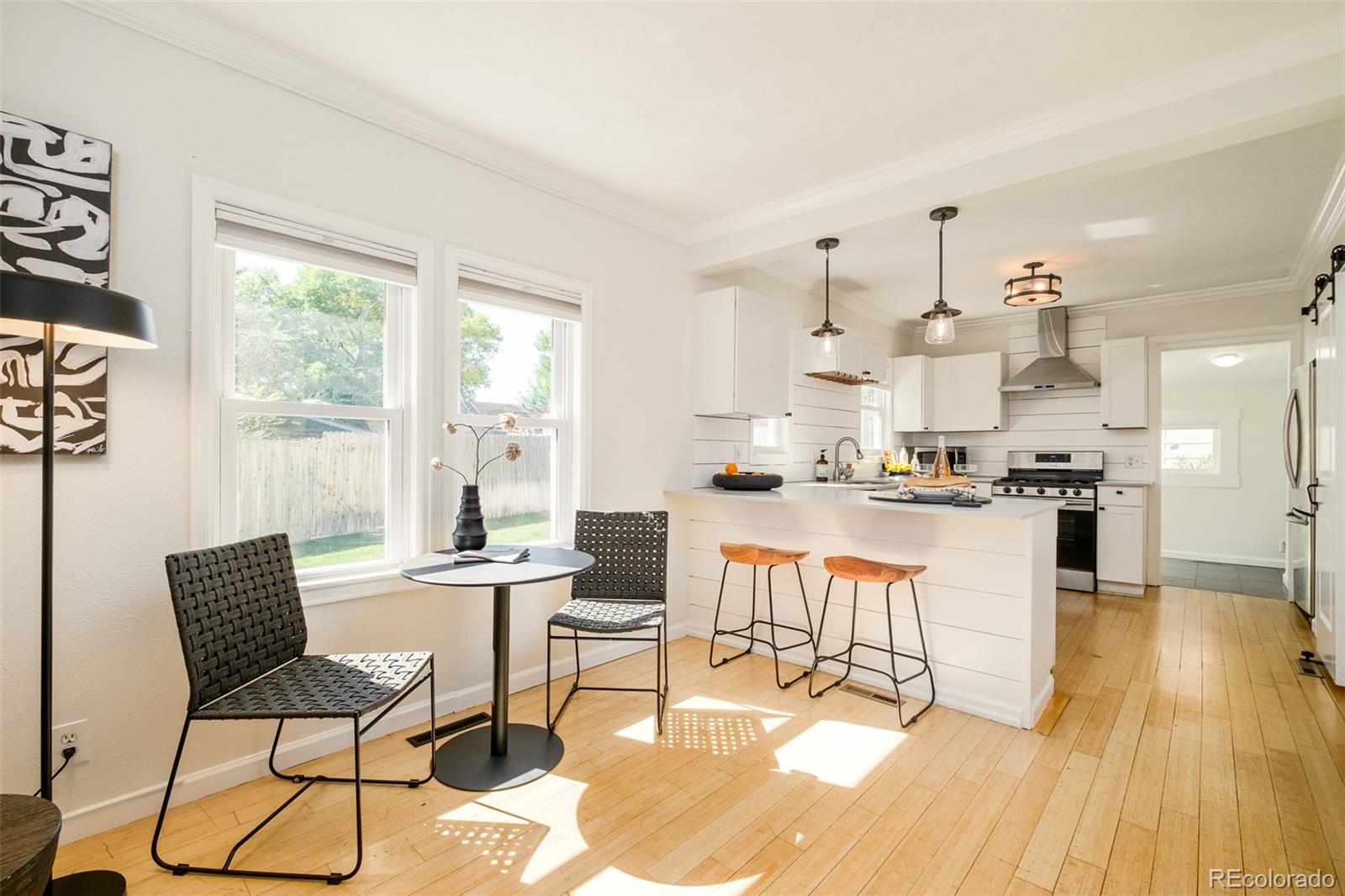 4635 Elm Court Denver, CO 80211 - Photo 5 of 28 a kitchen with stainless steel appliances kitchen island granite countertop a sink and cabinets