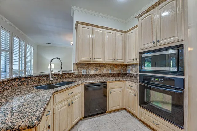 a kitchen with white cabinets and appliances