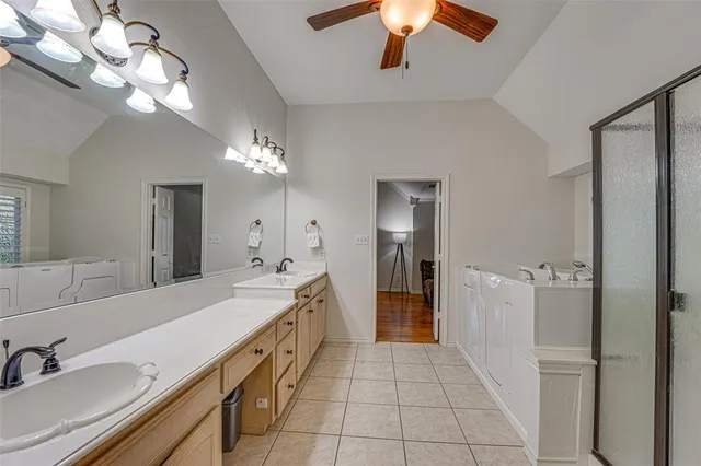 a spacious bathroom with a double vanity sink and a mirror