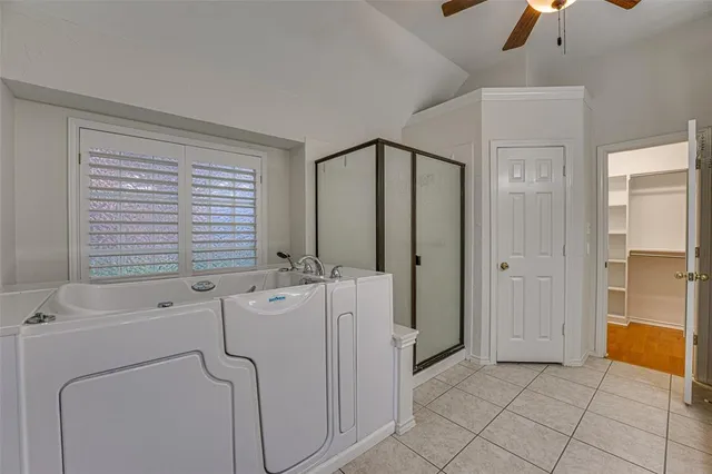 a view of bathroom with a bathtub a sink and mirror