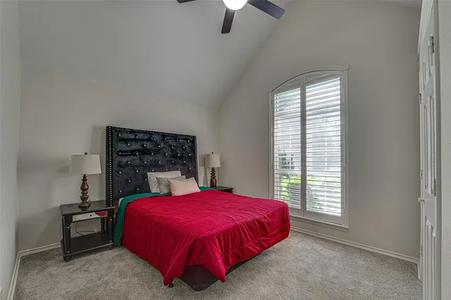a bed sitting in a bedroom next to a window