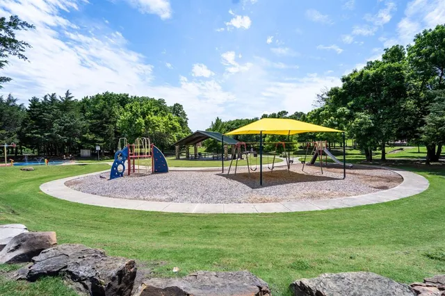 a swimming pool with outdoor seating and barbeque oven