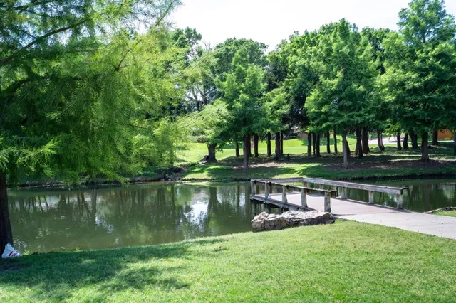 a view of a lake with a yard and a fountain