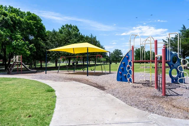a view of a park with swings and slides