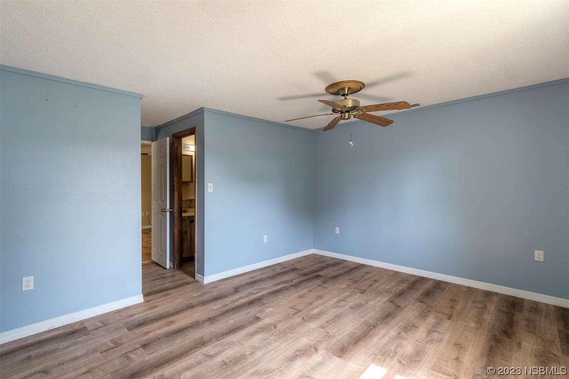 209 Pine Avenue Edgewater, FL 32141 - Photo 19 of 34 a view of a room with a ceiling fan and wooden floor