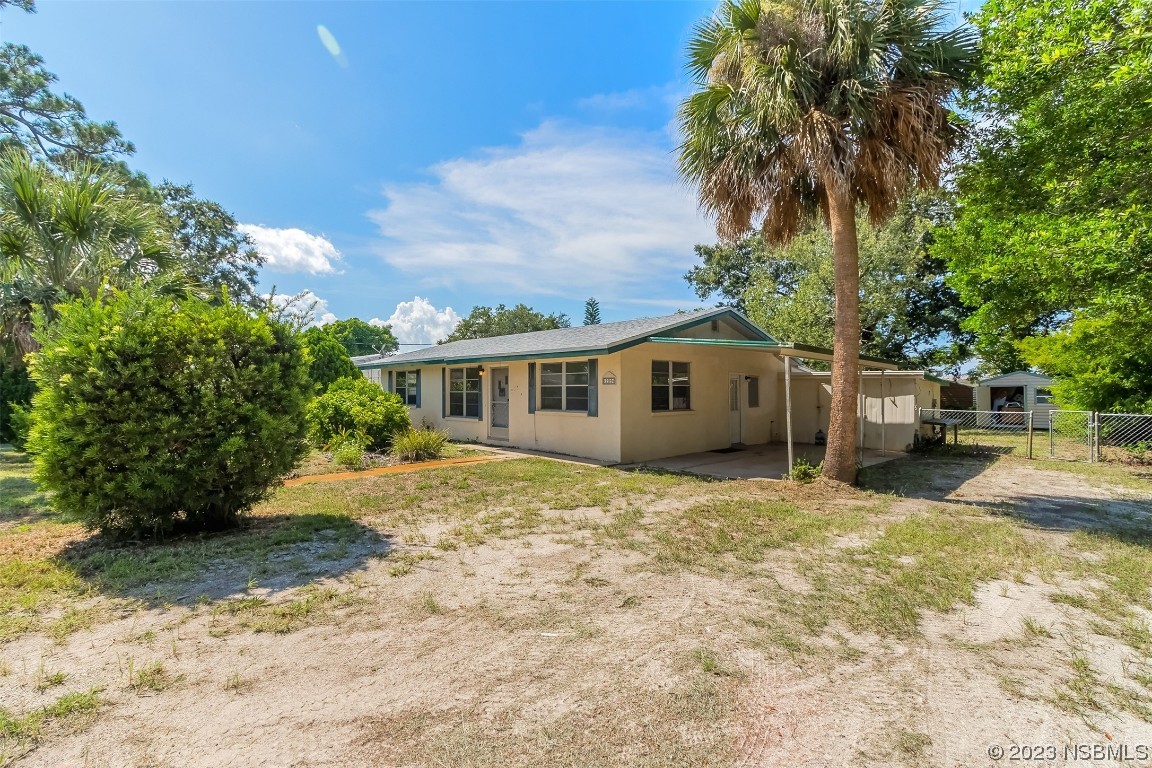209 Pine Avenue Edgewater, FL 32141 - Photo 2 of 34 a front view of a house with a garden