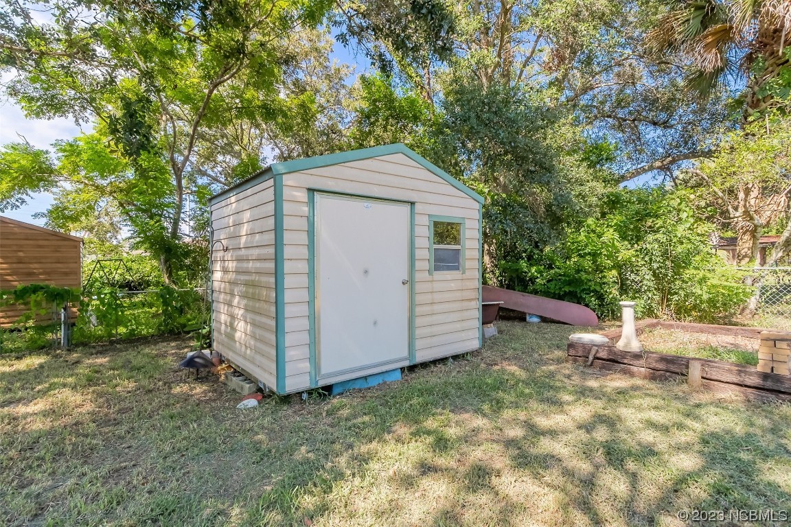 209 Pine Avenue Edgewater, FL 32141 - Photo 23 of 34 a view of a small house with a small yard and large tree