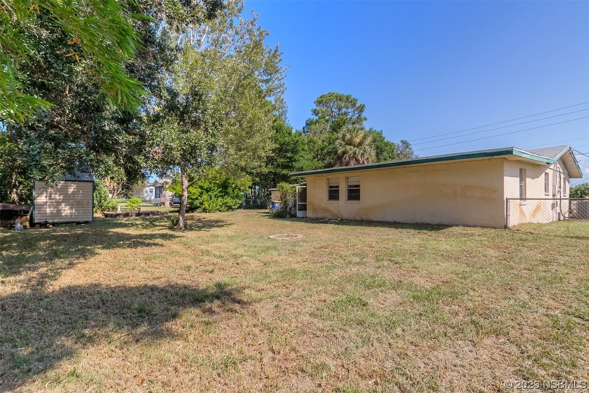 209 Pine Avenue Edgewater, FL 32141 - Photo 25 of 34 a backyard of a house with lots of green space