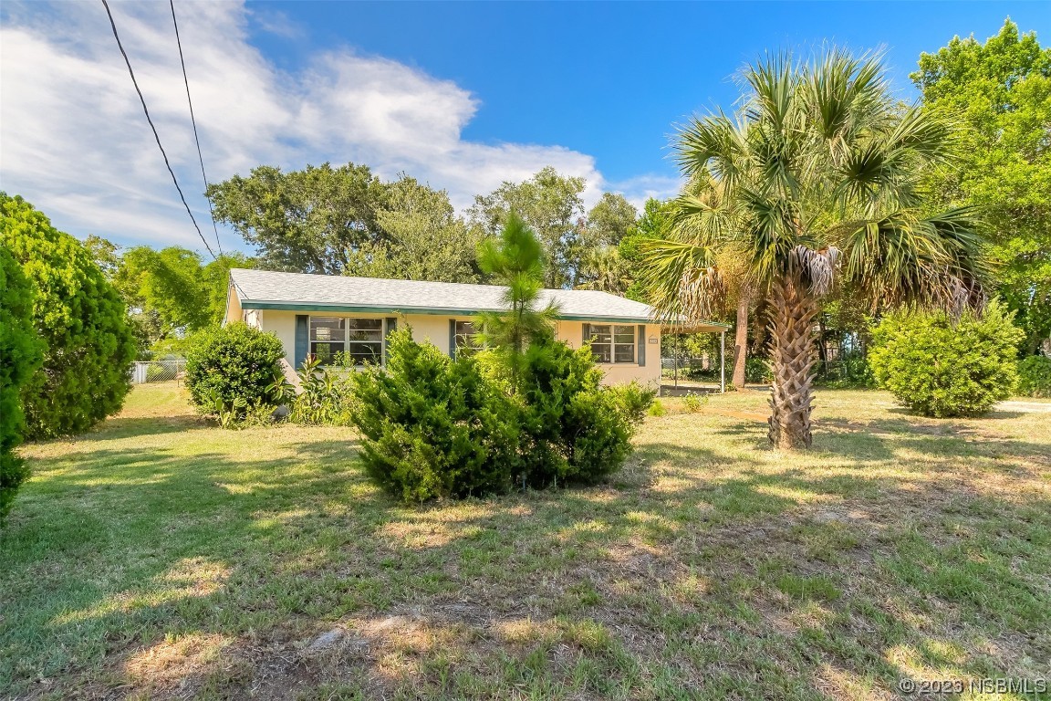 209 Pine Avenue Edgewater, FL 32141 - Photo 3 of 34 a front view of a house with a yard