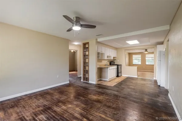 a view of a kitchen with wooden floor and a window