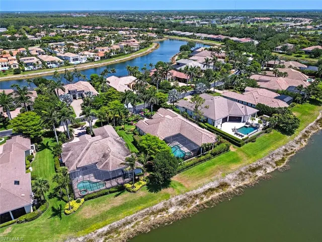 an aerial view of residential houses with outdoor space and lake view