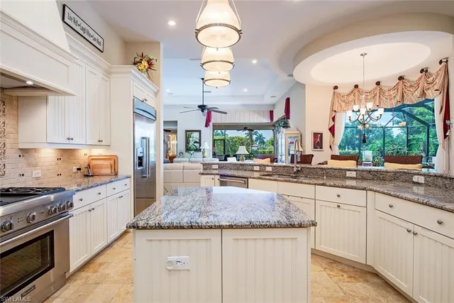 a kitchen with stainless steel appliances granite countertop a stove and cabinets