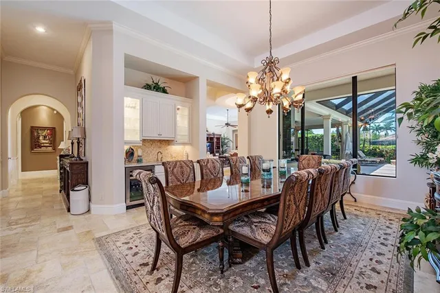 a view of a dining room with furniture and chandelier