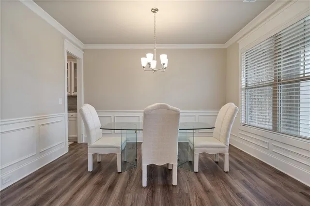 a view of staircase with lots of frames on wall and a window