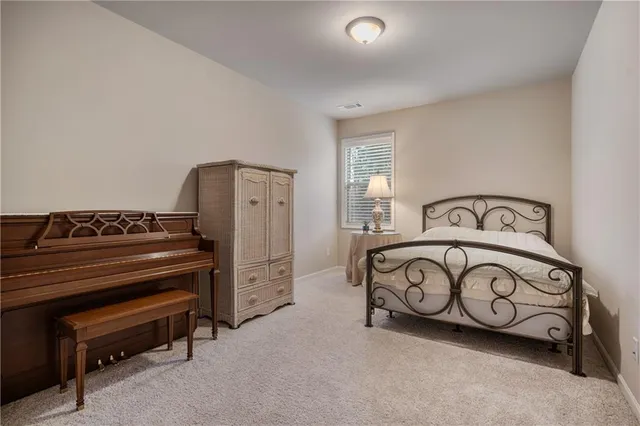 a bedroom with a bed a couch and dresser