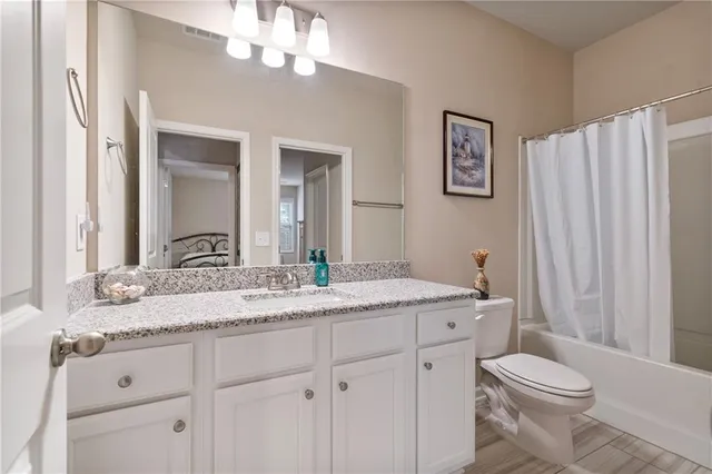 a bedroom with a bed a dresser and a book shelf