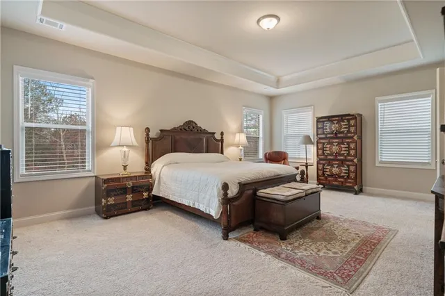 a white bath tub sitting next to a shower