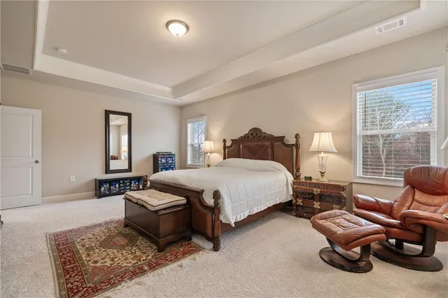 a bedroom with a bed and a lamp