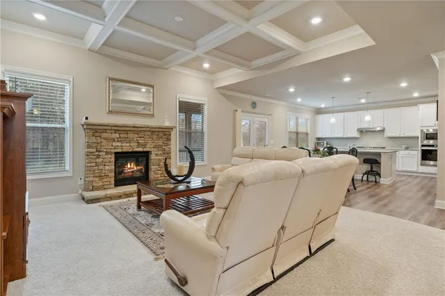 a living room with furniture a fireplace and a table
