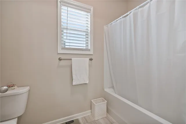 a view of an empty room with wooden walls