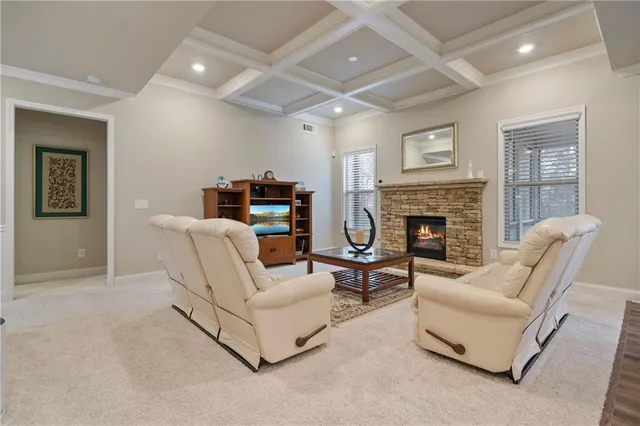 a kitchen with stainless steel appliances granite countertop white cabinets a sink a stove a refrigerator and island