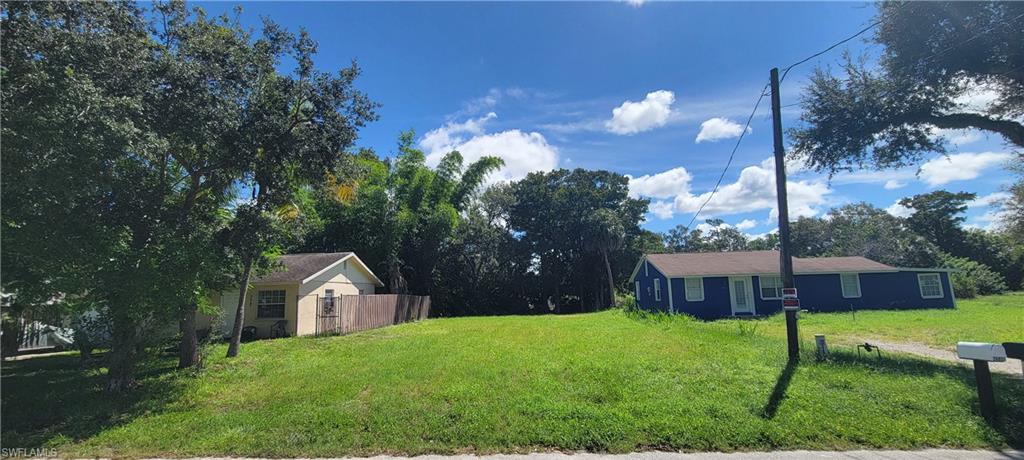 26791 North Riverside Drive Bonita Springs, FL 34135 - Photo 5 of 6 a view of a house with a backyard and a patio