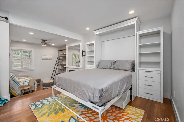 a bedroom with a bed and a view of closet