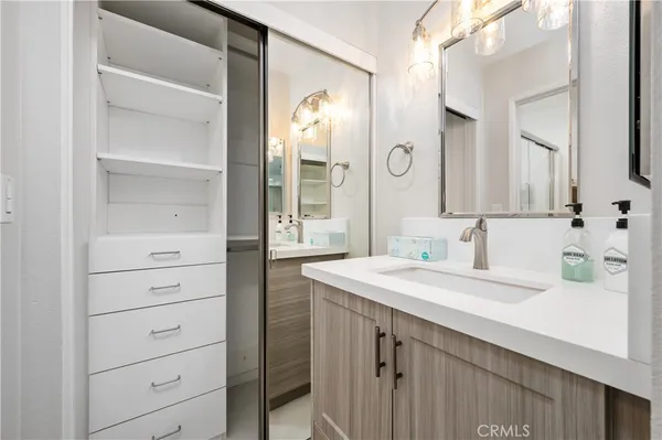a bathroom with a sink vanity and a mirror