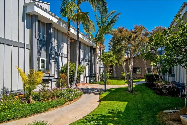 a view of a house with a yard and plants