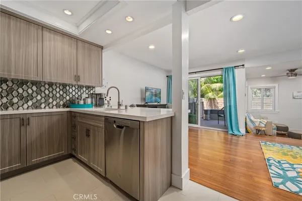 a kitchen with granite countertop a sink and cabinets