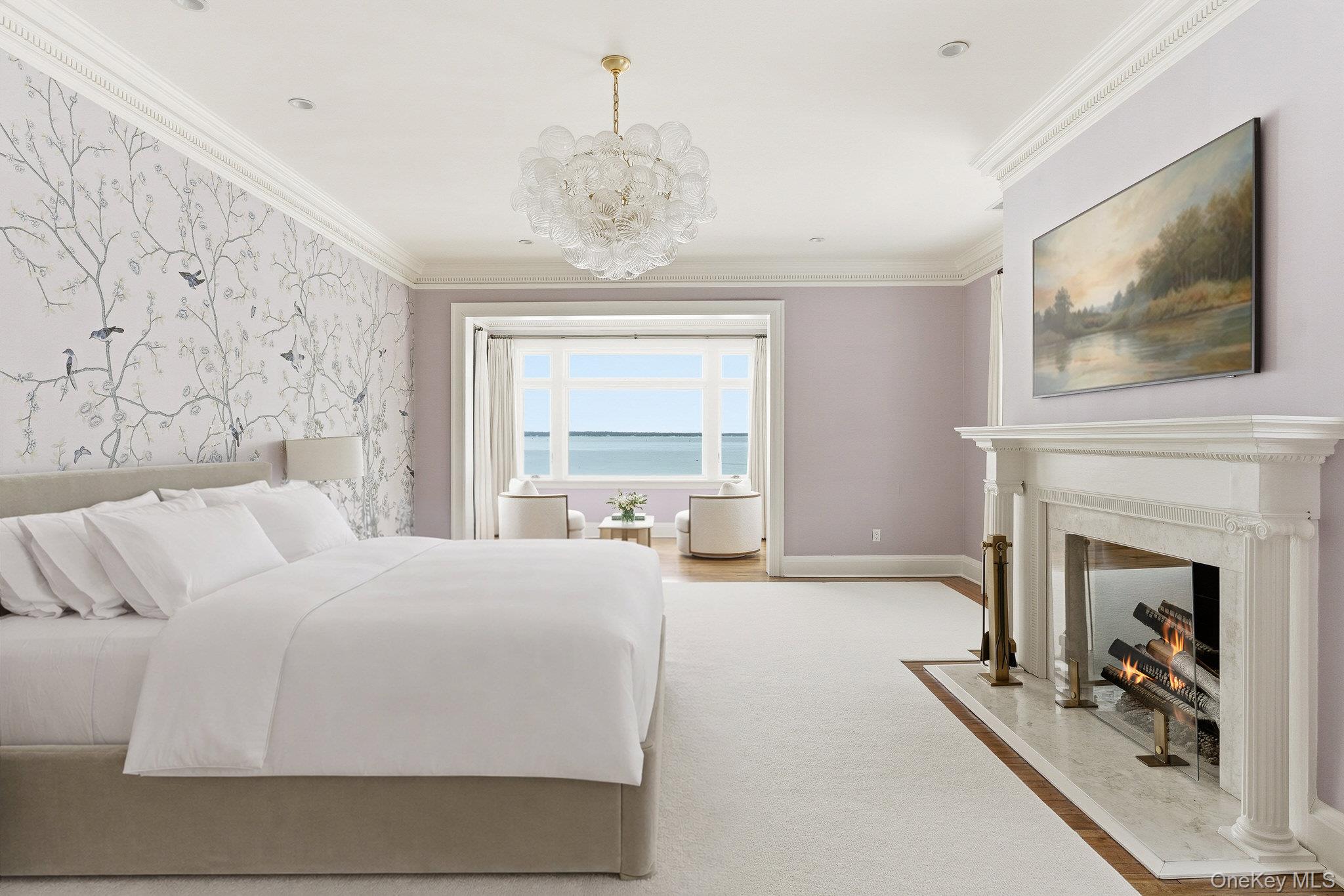 217 Hommocks Road Larchmont, NY 10538 - Photo 19 of 49 a bedroom with a large bed and a fireplace